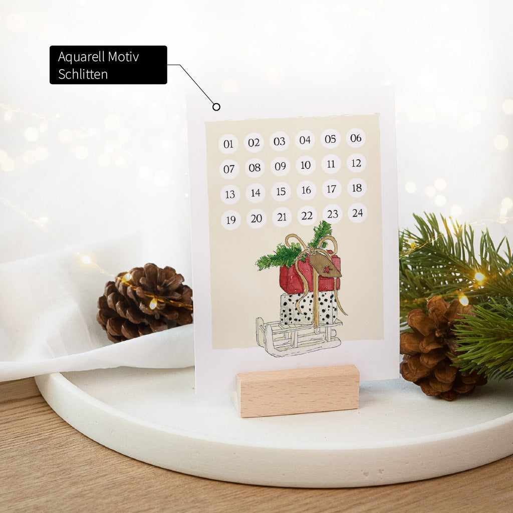 Countdown Karte für die Adventszeit mit einem Schlitten Aquarell Motiv im Kartenhalter aus Buchenholz.