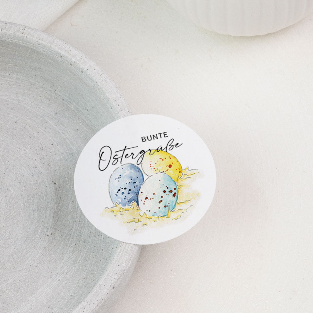 Runder Sticker auf Tablett, Motiv „Bunte Ostergrüße“ mit Ostereiern, Osteraufkleber für Ostern Geschenkverpackung.