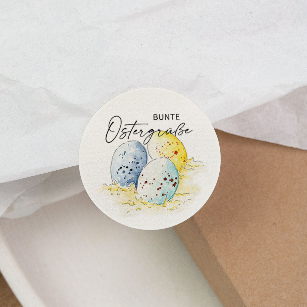 Runder Osteraufkleber auf Seidenpapier und Kraftkarton, „Bunte Ostergrüße“ mit Ostereiern, Deko-Sticker für Ostern.