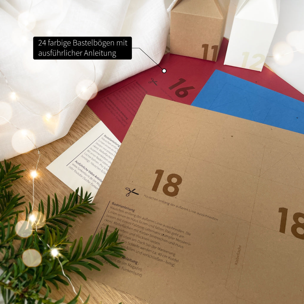 Detailaufnahme der Bastelbögen mit vorgedruckten Zahlen und Anleitung – Adventskalender-Häuschen aus farbigem Karton zum Selbermachen.