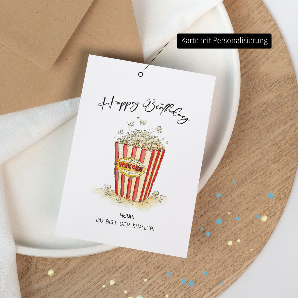 Geburtstagskarte mit handgezeichnetem Popcorn-Illustration im Aquarellstil, personalisierbar mit Namen und Spruch, hochwertig auf mattem Karton gedruckt.