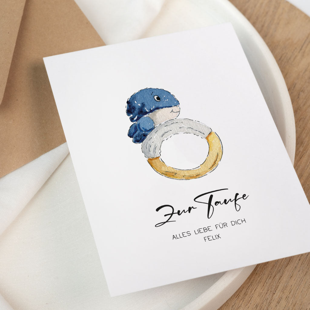 Weiße Glückwunschkarte zur Taufe mit handgemaltem Wal und Name Felix auf hellem Hintergrund