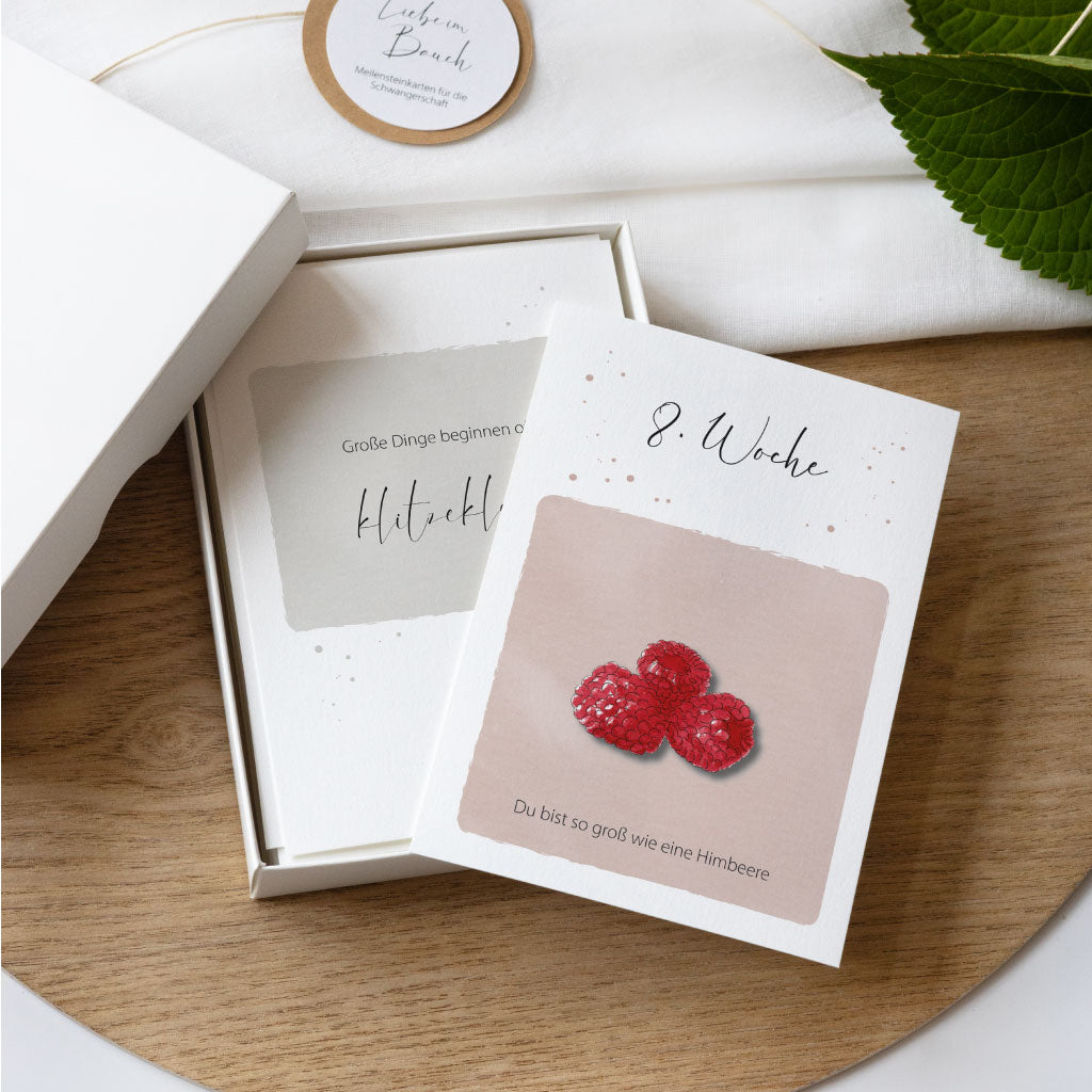 Meilensteinkarten für die Schwangerschaft, offene Geschenkschachtel mit Karte 8. SSW Himbeere