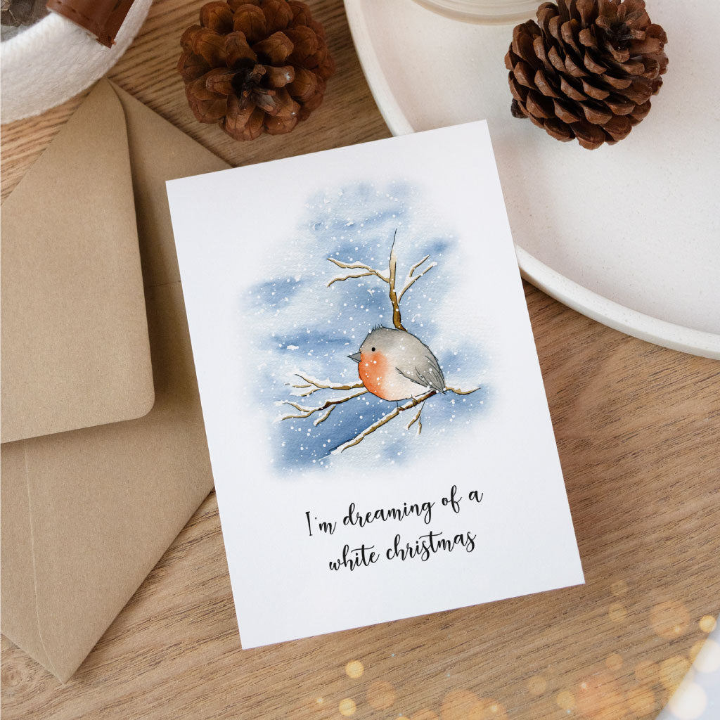 Spruch: I´m dreaming of a white christmas und Rotkehlchen auf verschneitem Ast als Motiv