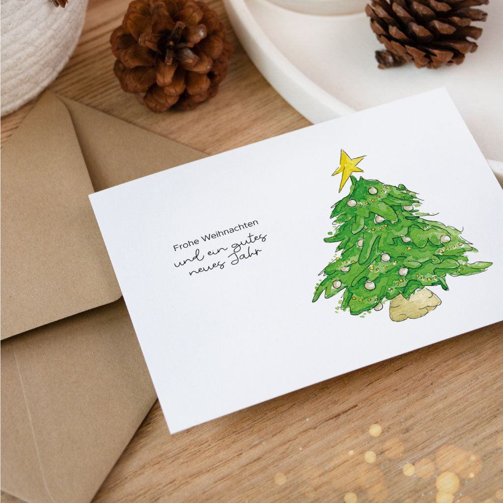 Postkarte mit Aquarell-Weihnachtsbaum und Schriftzug „Frohe Weihnachten und ein gutes neues Jahr“, stimmungsvoll dekoriert – ideal für persönliche Weihnachtsgrüße oder zum Weihnachtsgeschenke verpacken.