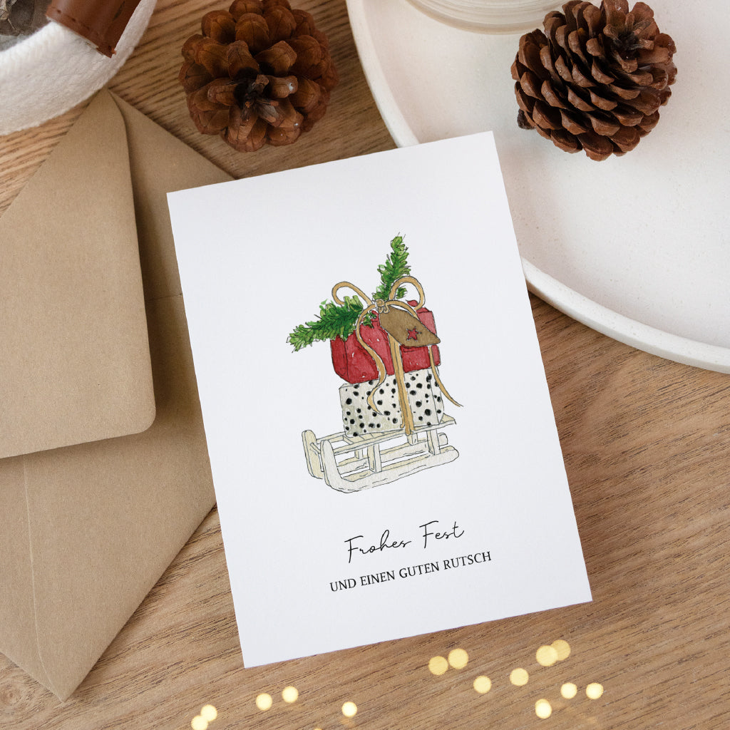 Hochwertige Klappkarte für Weihnachten mit handgemaltem Geschenke Aquarell Motiv und Umschlag aus Kraftpapier.