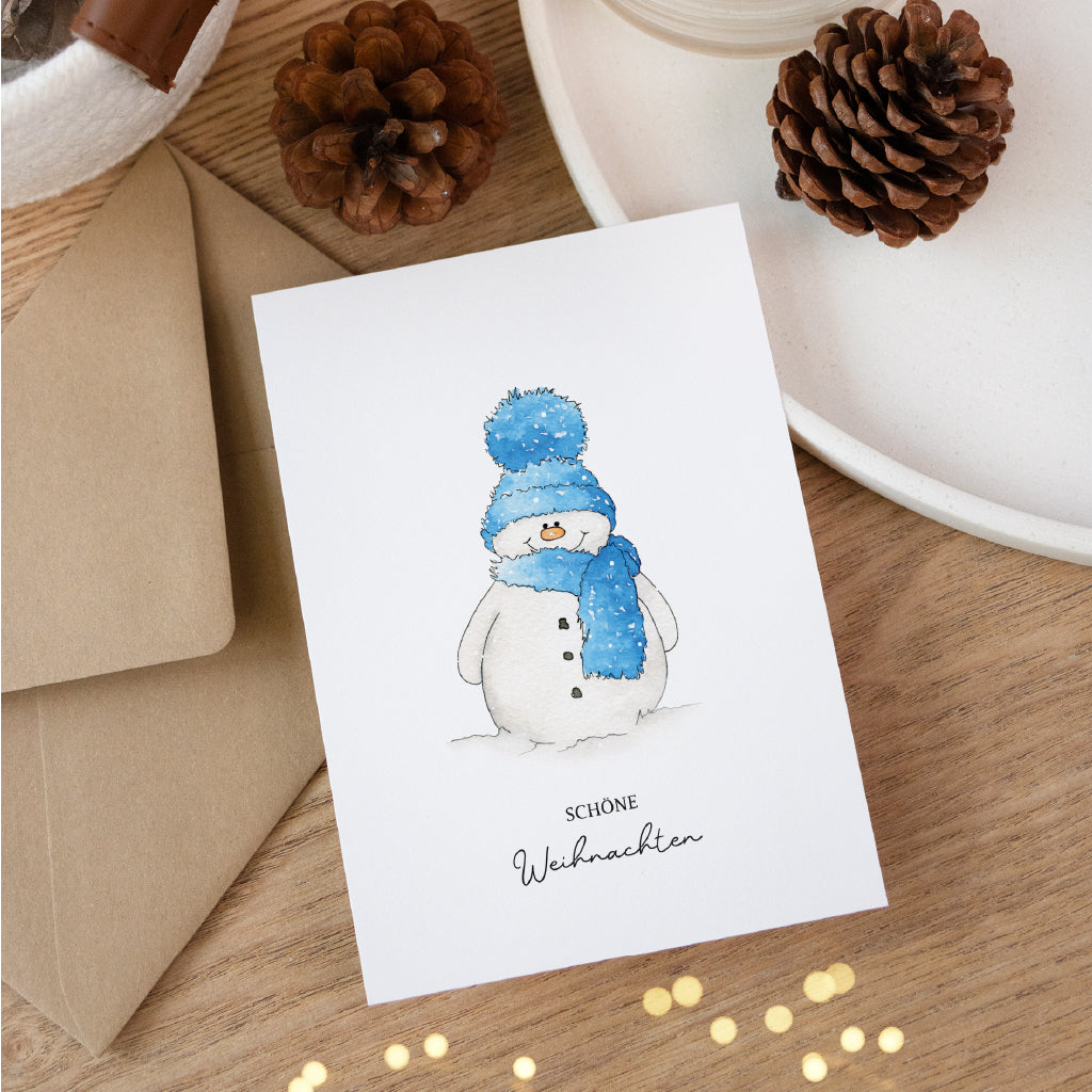 Postkarte mit einem Schneemann im Schnee. Ein handgemaltes Aquarell Motiv ideal für deine Weihnachtspost.