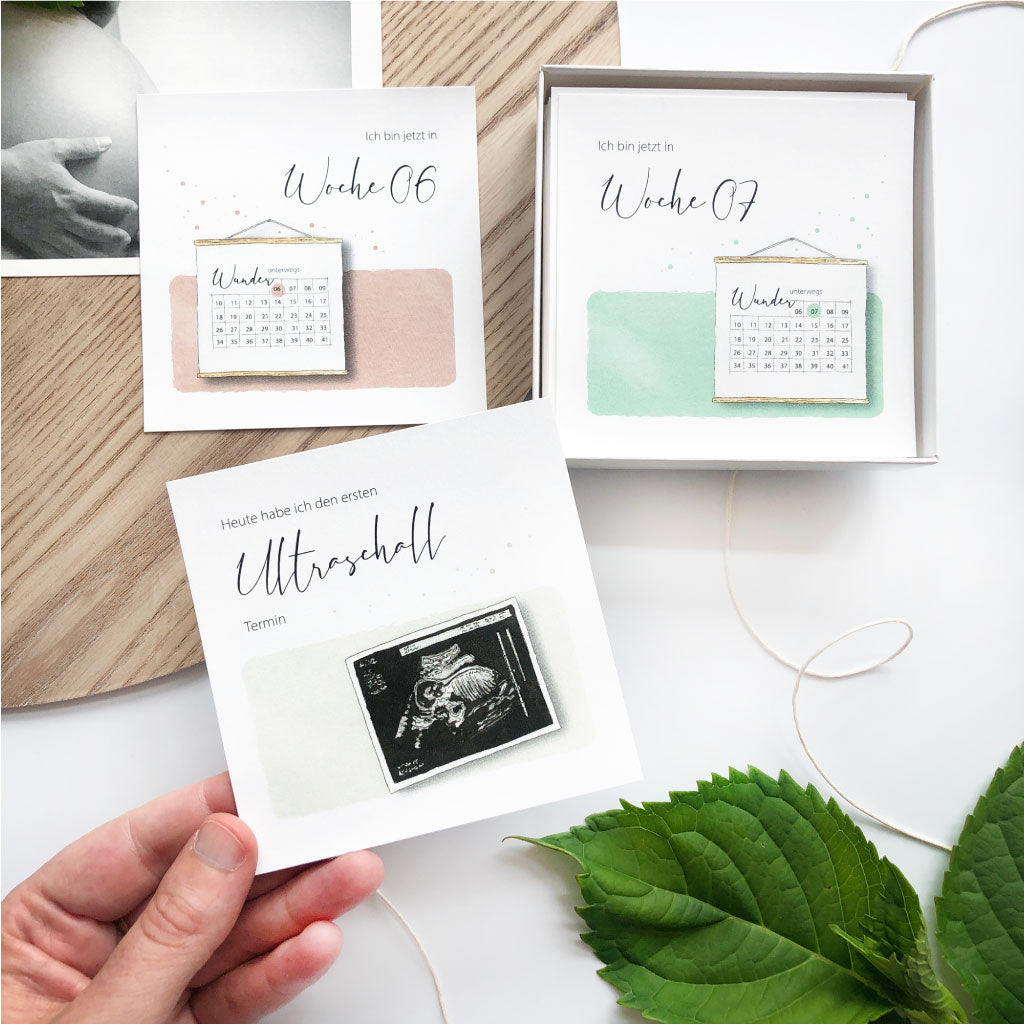 Karte "Heute habe ich den ersten Ultraschalltermin" vor offener Schachtel