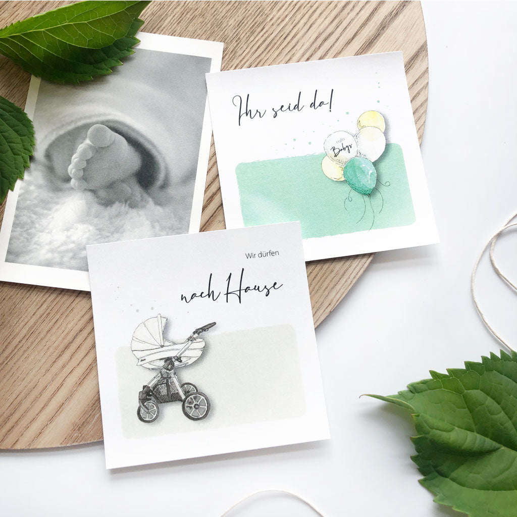 Karten "Wir dürfen nach Hause" mit Kinderwagen und "Ihr seid da" mit Luftballons