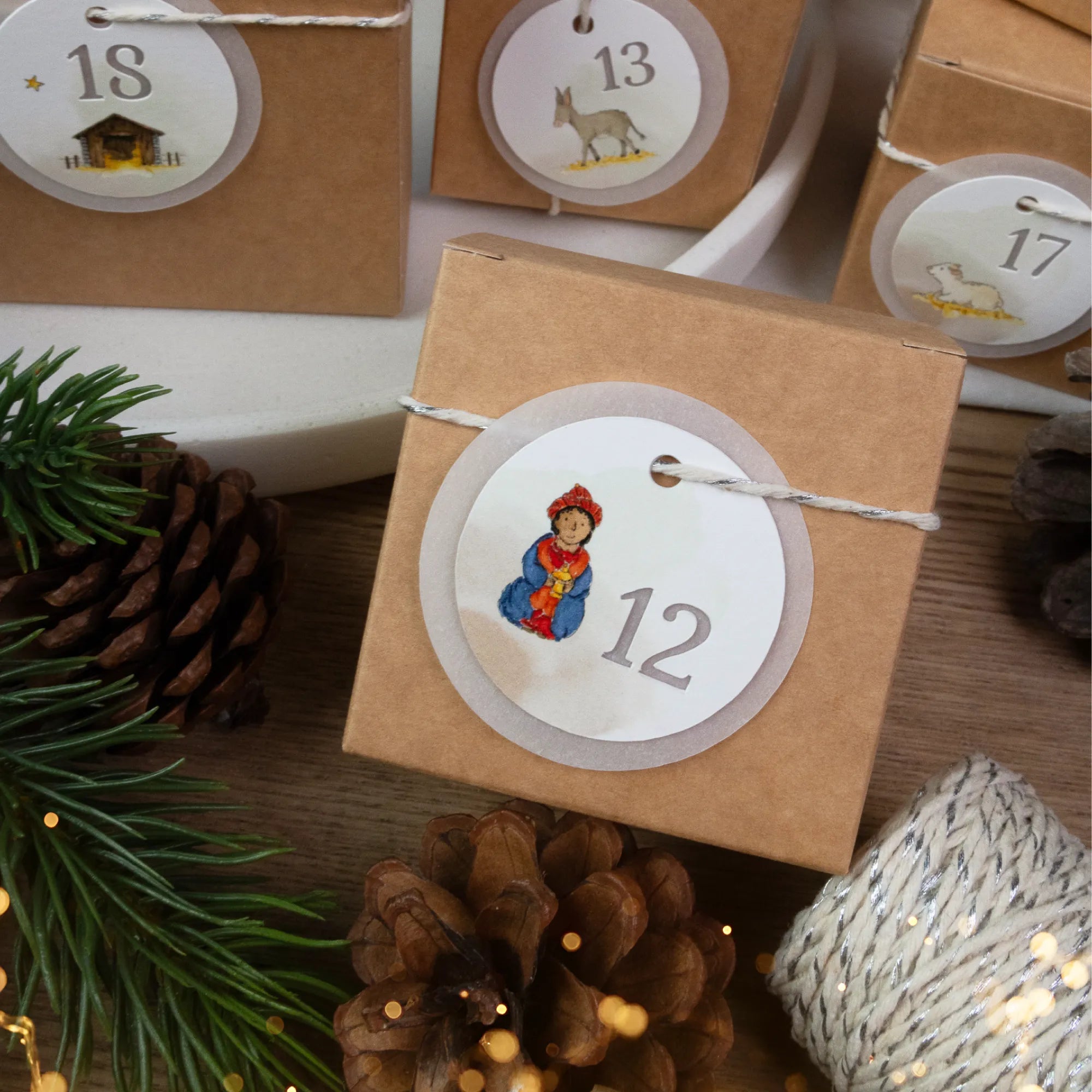 Liebevoll gestalteter DIY Adventskalender mit Kraftkarton Schachteln und einem transparenten Krippe Aquarell Motiv.