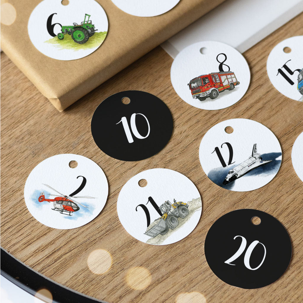 Adventskalender-Anhänger mit Fahrzeugmotiven: Zahl 2 mit Rettungshubschrauber, Zahl 6 mit grünem Traktor, Zahl 8 mit Feuerwehrauto, Zahl 10 ohne Motiv, Zahl 12 mit Raumfähre, Zahl 20 ohne Motiv, Zahl 21 mit Radlader