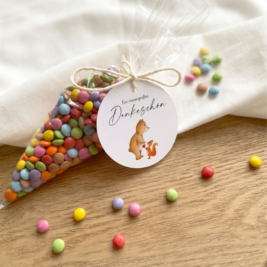 Bastelidee Abschiedsgeschenk Lehrerin mit befüllter Spitztüte und Dankeschön Anhänger auf Holztisch.