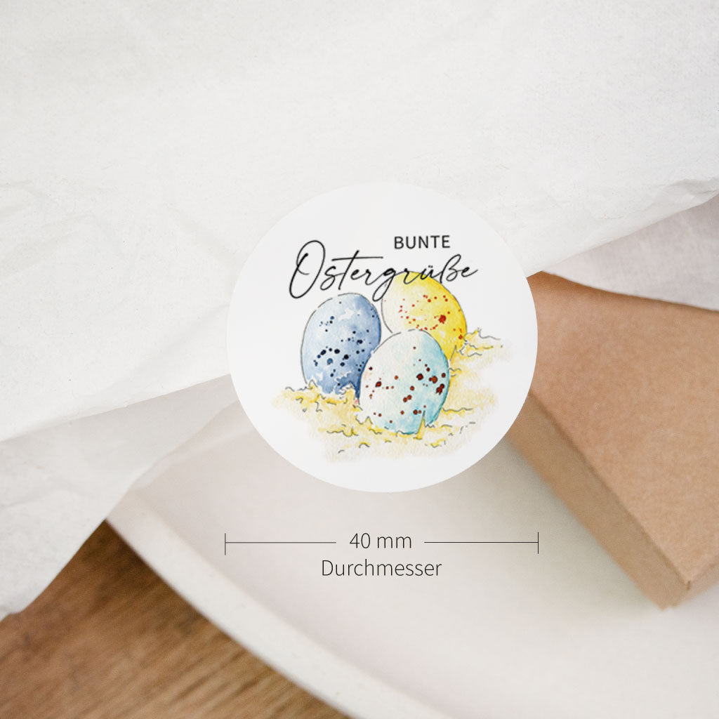 Größenangabe: runder Osteraufkleber 40 mm Durchmesser, Motiv „Bunte Ostergrüße“ mit Ostereiern, Sticker für Deko.