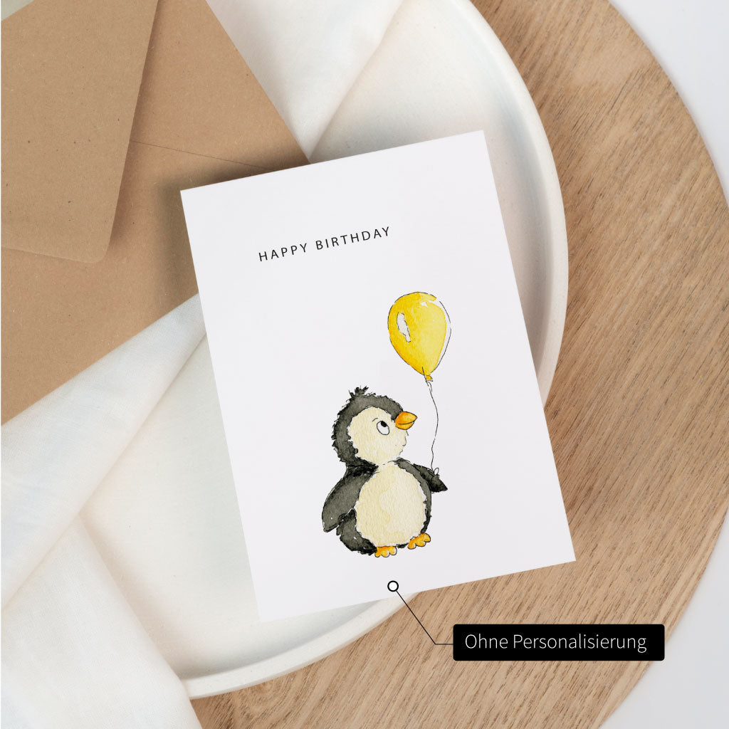 Glückwunschkarte mit einem Pinguin, der einen Luftballon hält