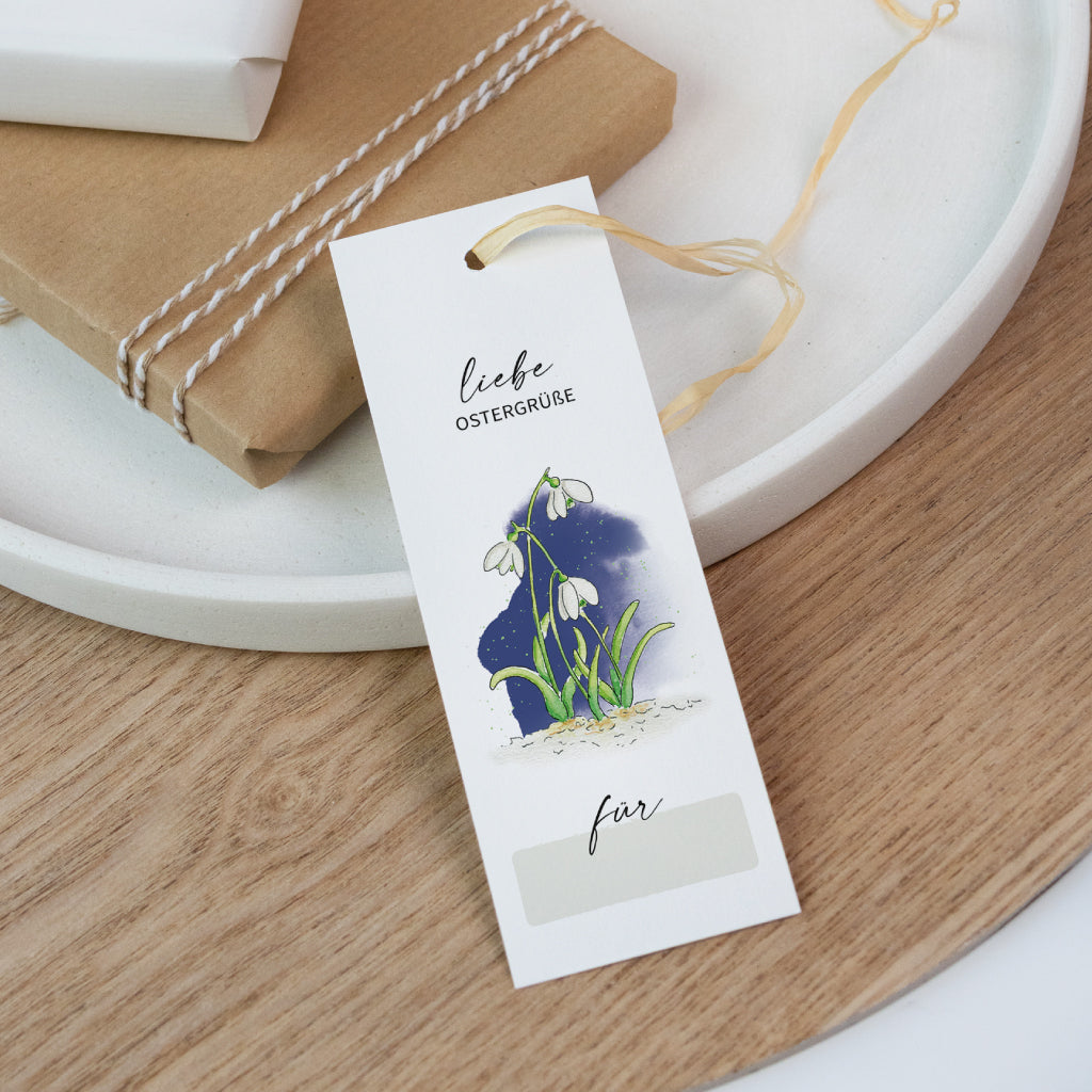 Dekorativer Geschenkanhänger zu Ostern mit Schneeglöckchen-Aquarell und der Aufschrift „Liebe Ostergrüße“ – perfekt für Frühlingsdeko oder Osterpräsente.