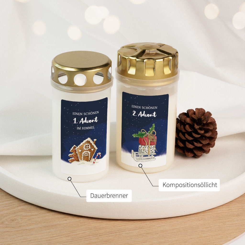 Vergleich von Dauerbrenner- und Kompositionsöllicht-Grabkerze mit Aquarellmotiven zum 1. und 2. Advent – stimmungsvoll zur Weihnachtszeit.