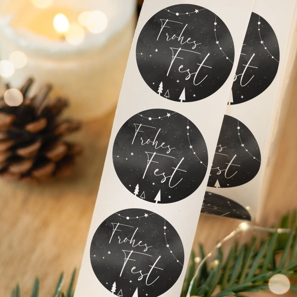 Schwarzer Weihnachtsaufkleber mit weißem Text "Frohes Fest"