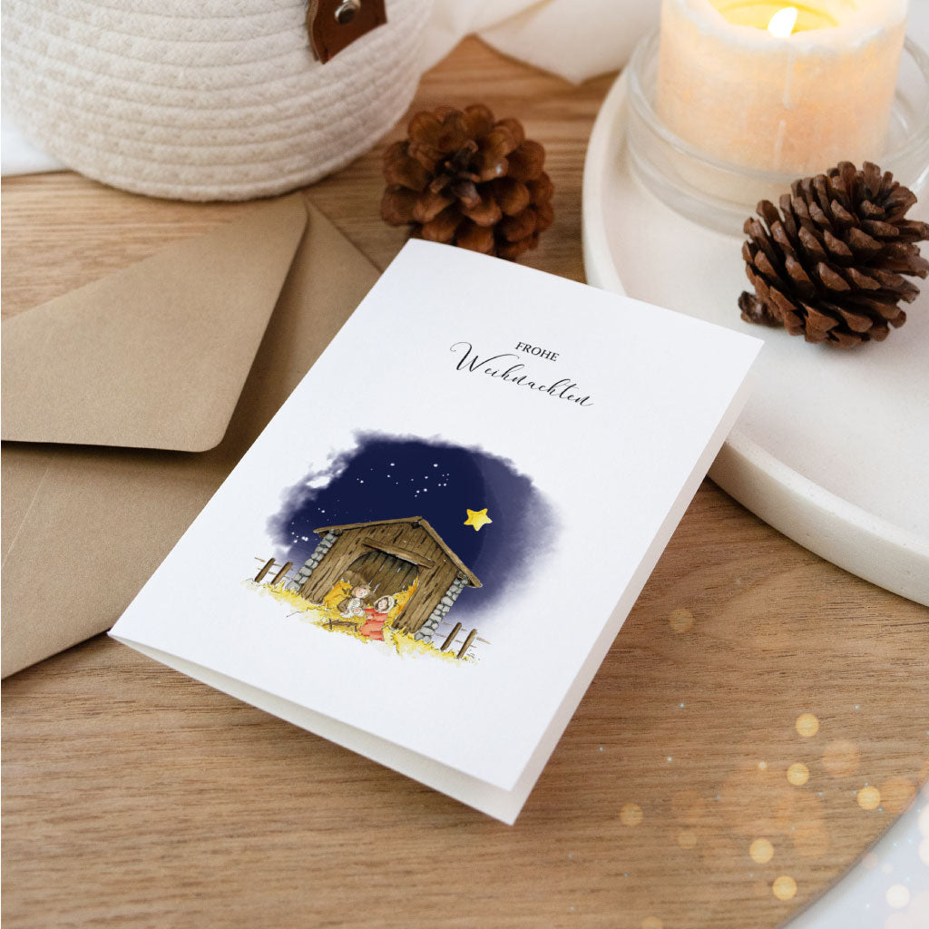 Weihnachtskarte mit christlichem Aquarellmotiv von Maria, Josef und dem Jesuskind im Stall unter Sternenhimmel, ideal für besinnliche Grüße im Winter.