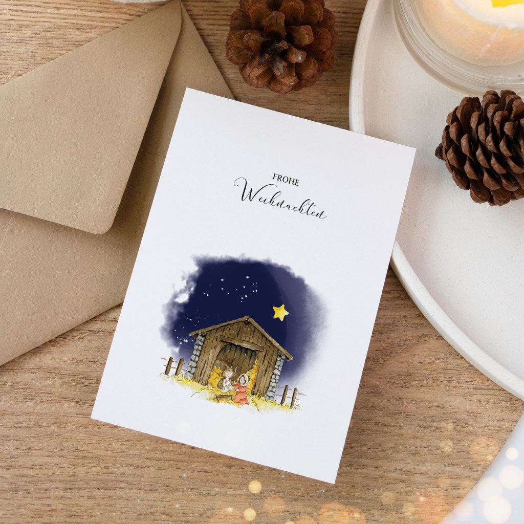 Künstlerisch gestaltete Klappkarte mit Krippe, Stern und Schriftzug „Frohe Weihnachten“ – christliche Weihnachtskarte für den Advent.